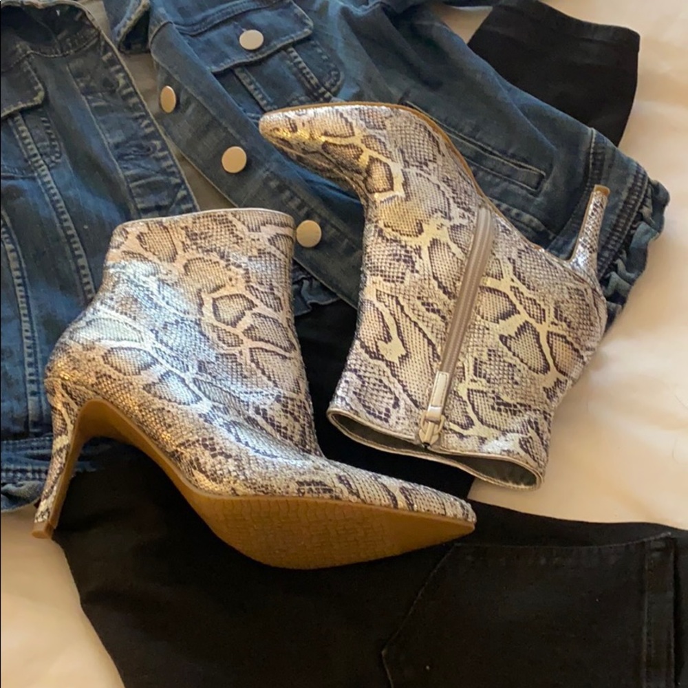 Silver snakeskin textured high heeled boots.
